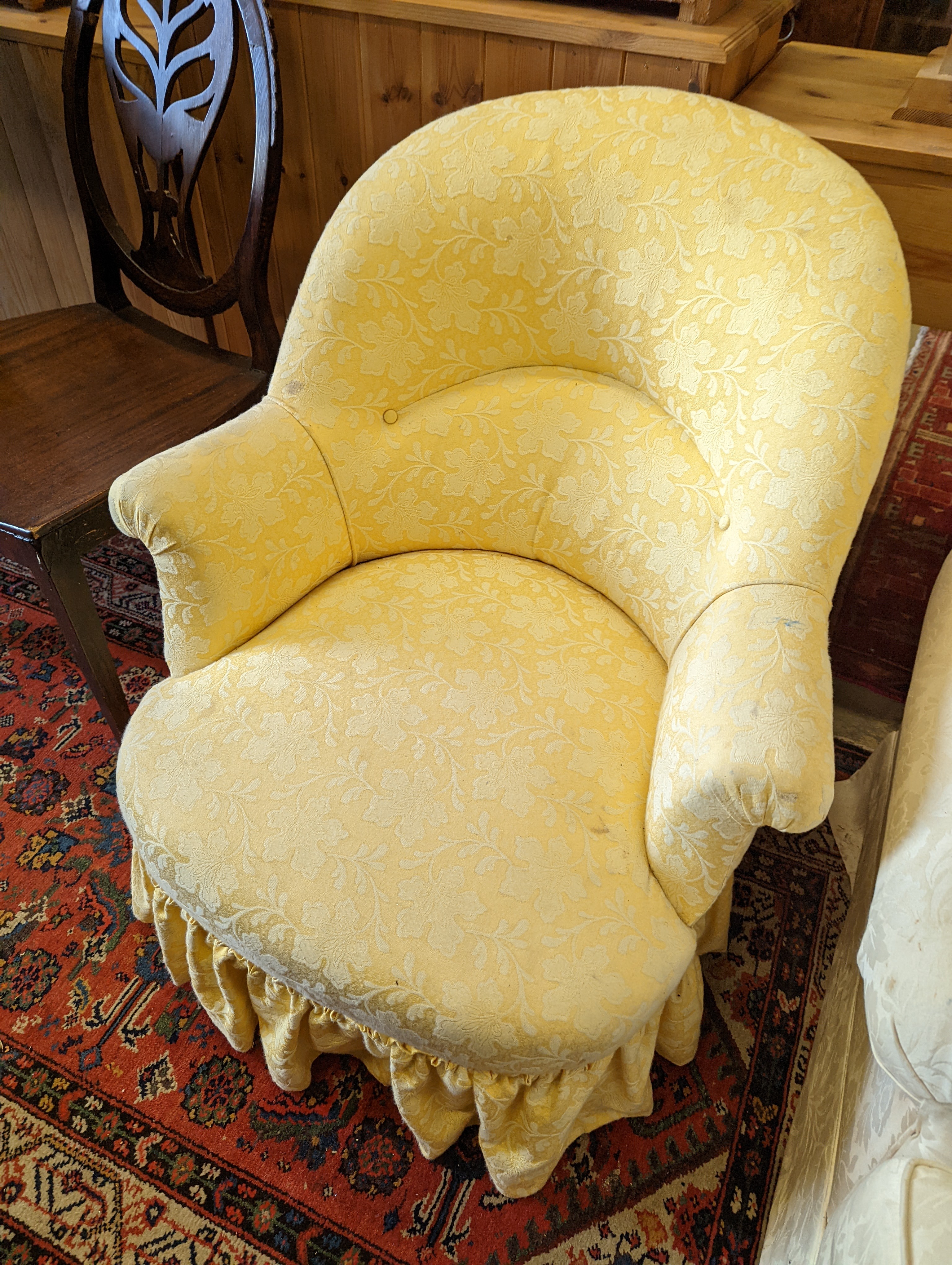 A brown leather upholstered desk chair, a mahogany hall chair and two upholstered armchairs